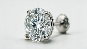 A single diamond stud isolated on a bone-white surface under clinical lighting