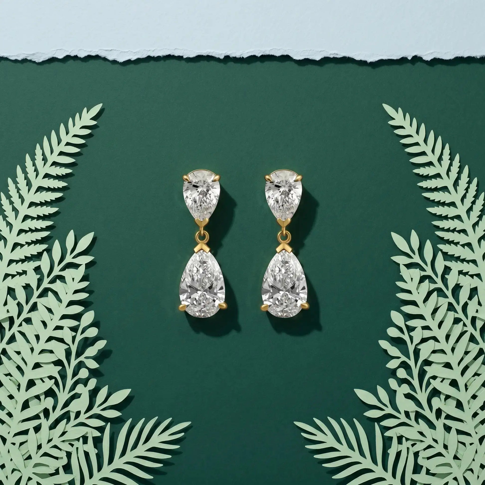 Duet pear-cut lab-grown diamond drop earrings worn on the ear