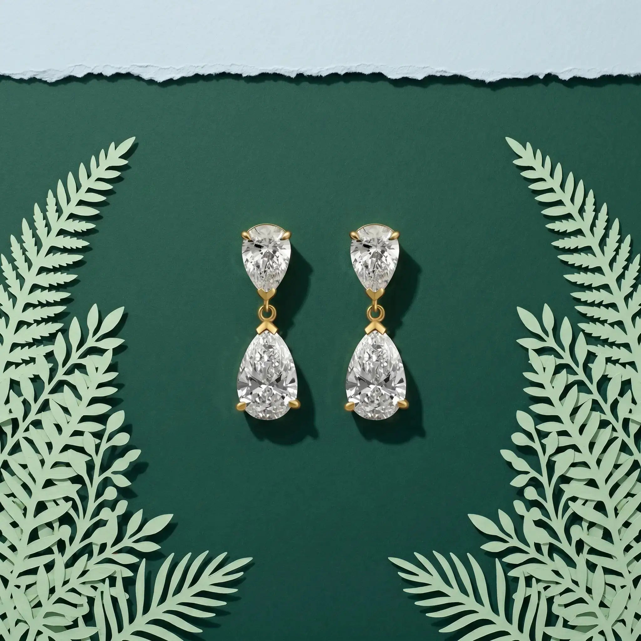 Duet pear-cut lab-grown diamond drop earrings worn on the ear