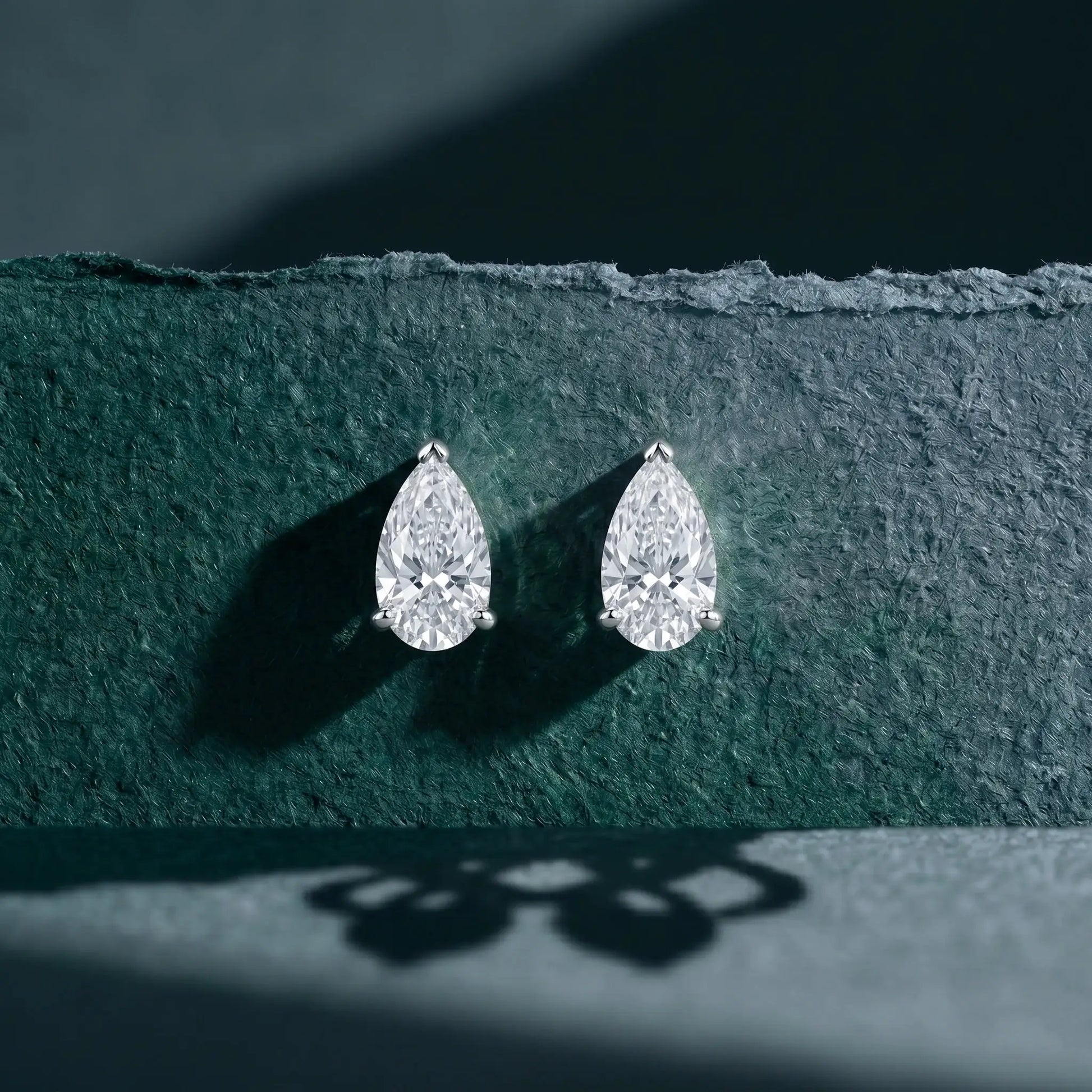 Paradigm pear-cut lab-grown diamond stud earring close-up with a protective V-prong