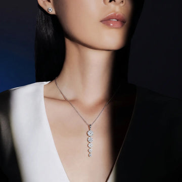 Woman wearing a diamond necklace with a dark background