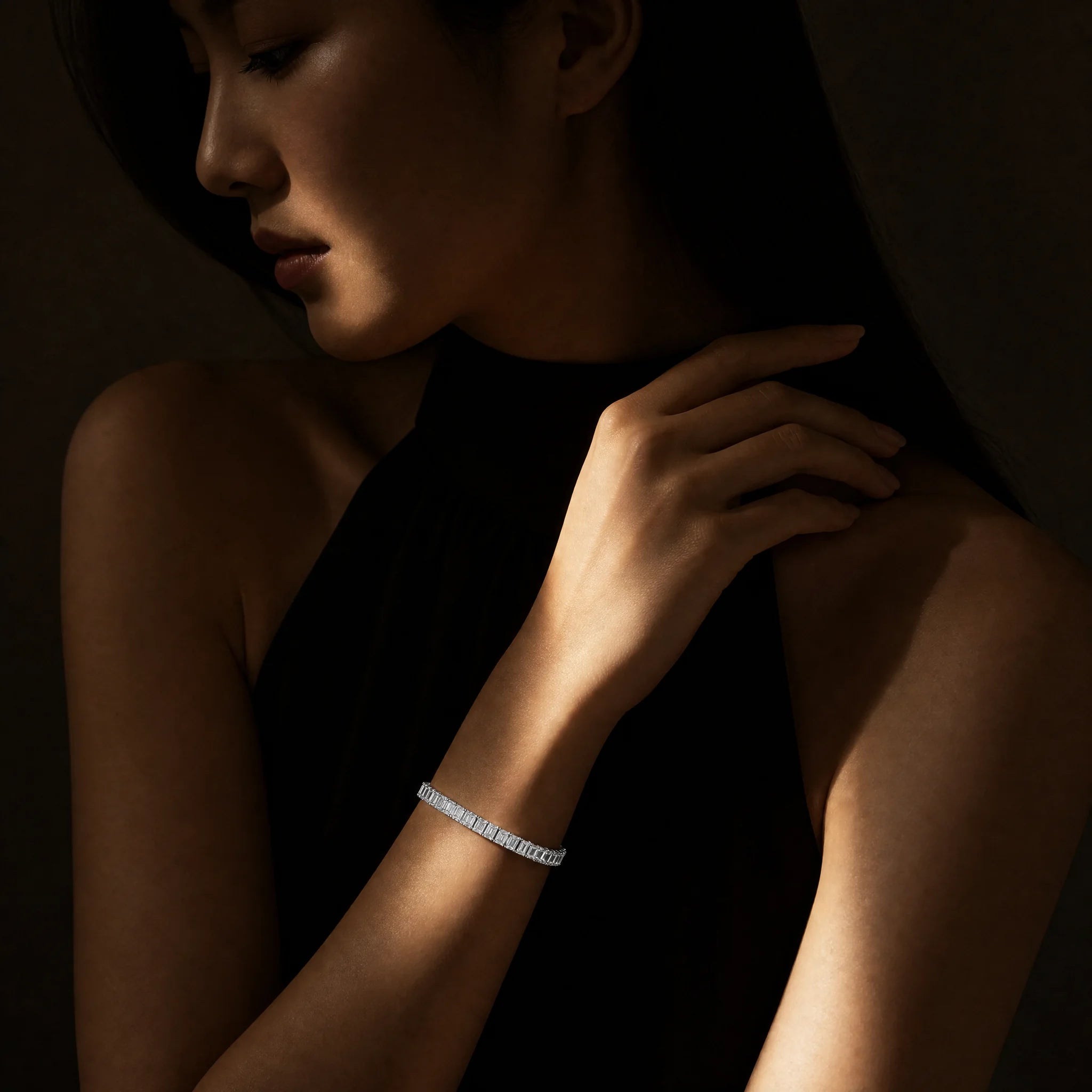 Meridian men's emerald-cut tennis bracelet worn on a woman's wrist, Carat Club Co.